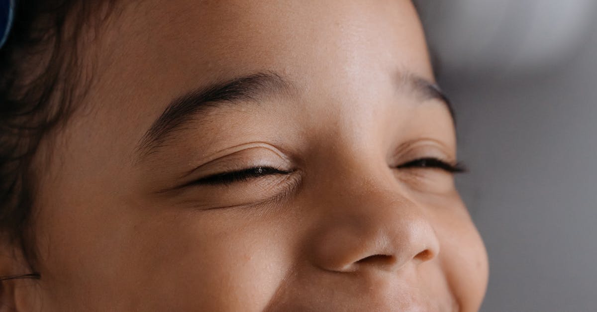 Smiling child undergoing dental x-ray at a clinic, emphasizing dental health and care.